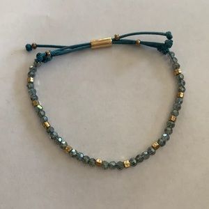 Adjustable beaded string bracelet